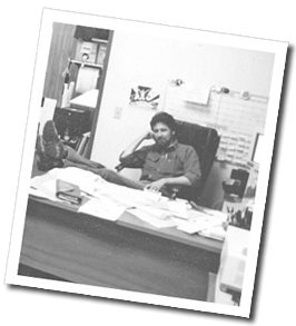 Ed Berland, in 1984, sitting at his desk at Berland Design Group.